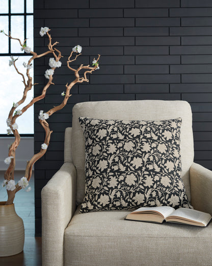 Floral throw pillow with black cover and beige botanical pattern on front