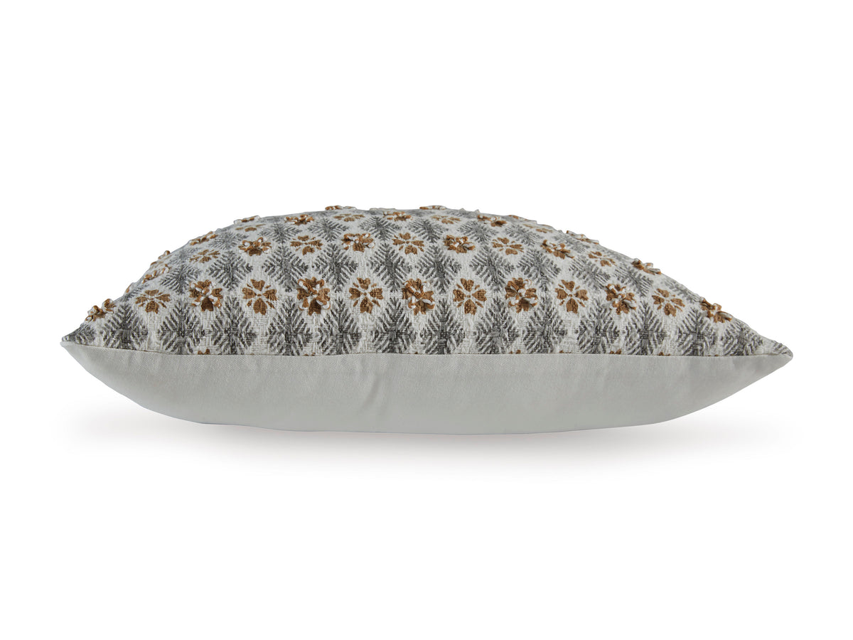 Light gray decorative pillow with brown floral pattern on top, piped edges
