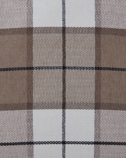 Close-up plaid pillow fabric with brown, taupe, white, and dark blue grid