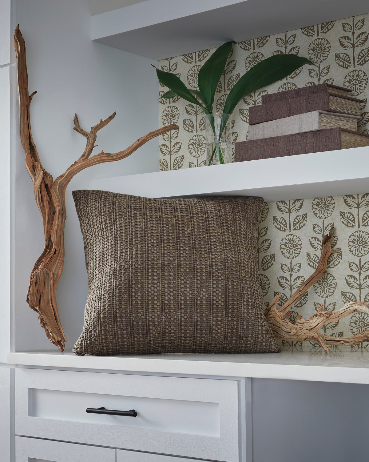 Textured decorative pillow with horizontal stitched pattern in taupe-brown