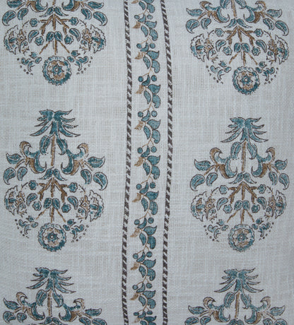 Close-up of white pillow fabric with blue and tan ornate floral medallions