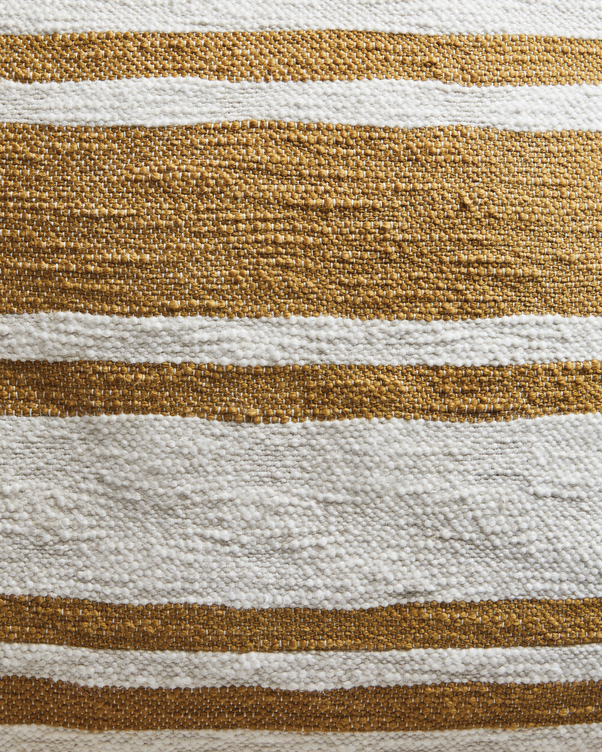 Close-up of woven pillow fabric with alternating brown and white stripes