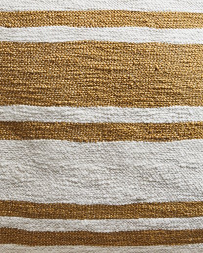 Close-up of woven pillow fabric with alternating brown and white stripes