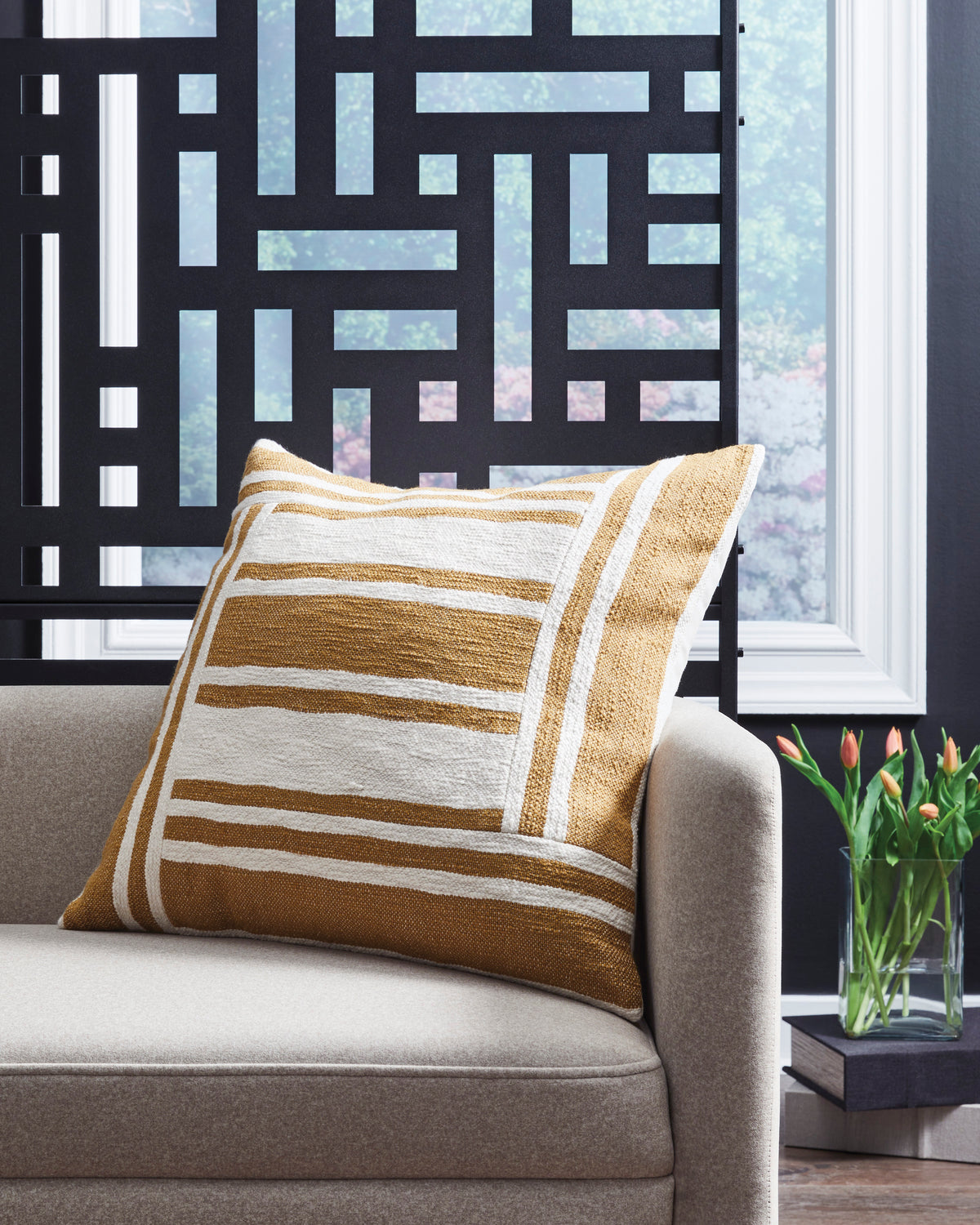 Striped throw pillow with brown and beige bands and stitched edges