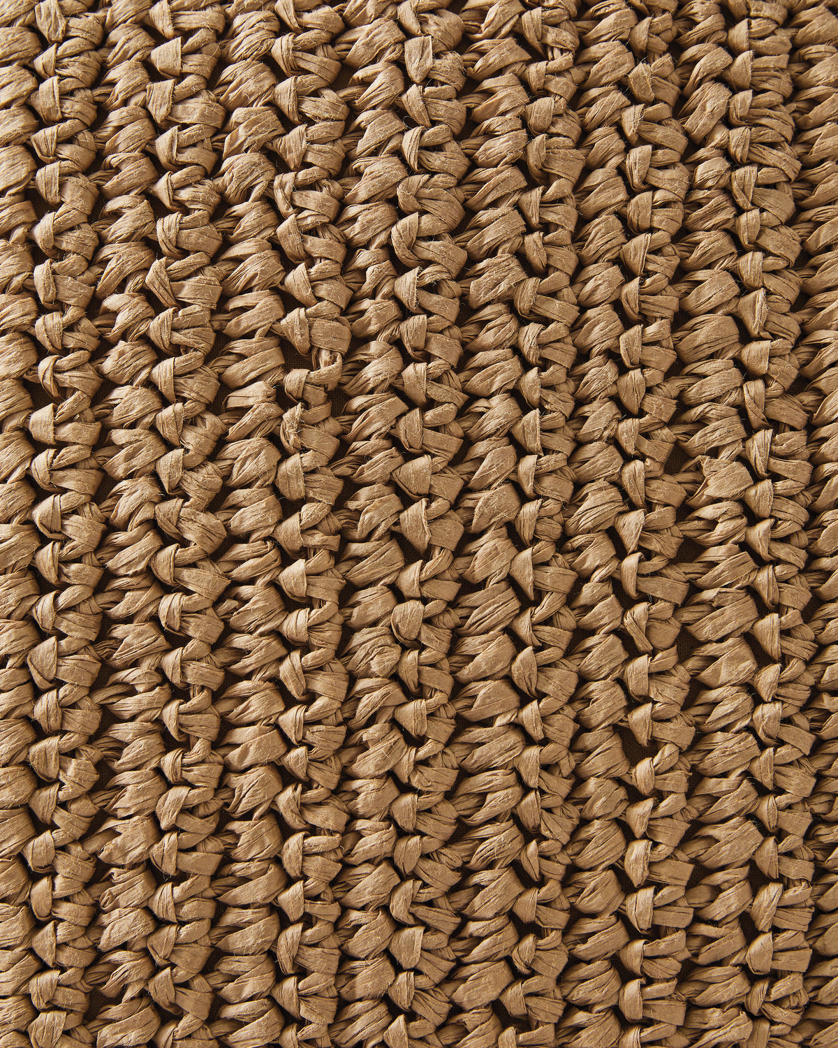Close-up of woven tan pillow fabric with crisscross straw-like texture
