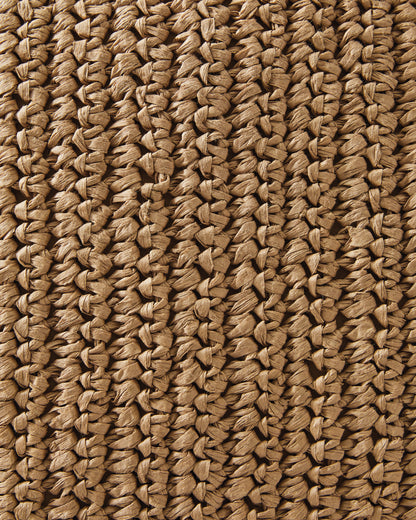 Close-up of woven tan pillow fabric with crisscross straw-like texture