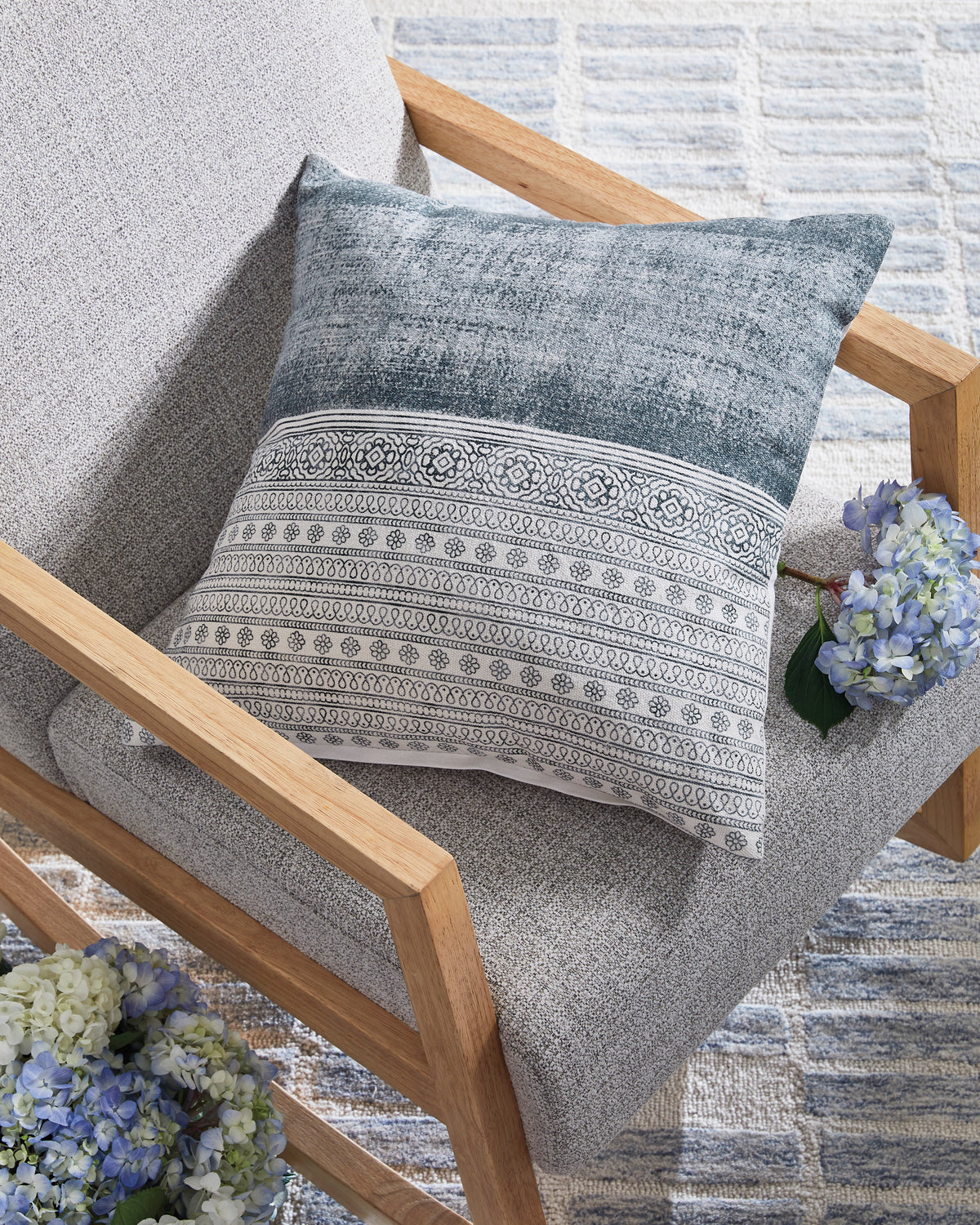 Blue and gray decorative throw pillow with horizontal patterned band