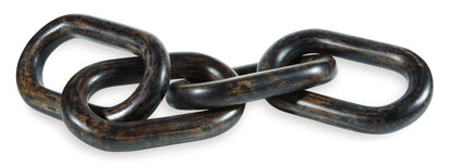 Close-up of dark metal chain-link sculpture with interlocked oval rings