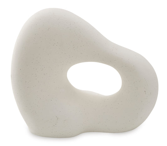 Abstract teardrop sculpture in off-white with oval hole, close-up view