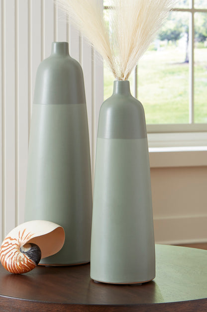 Pair of tall matte ceramic vases with narrow necks and flared rims, each with dried grass