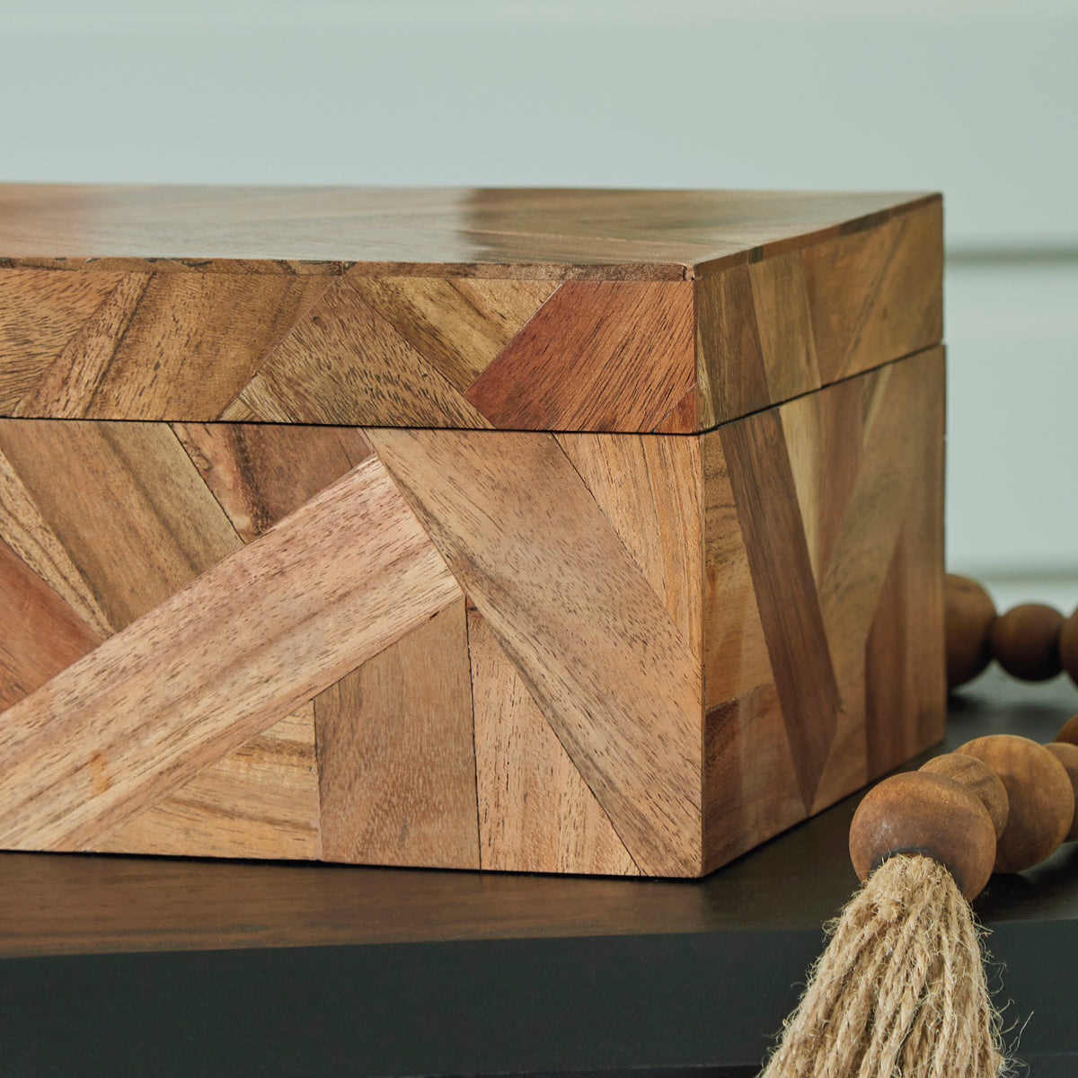 Large wooden storage box with patchwork design and curved lid seam