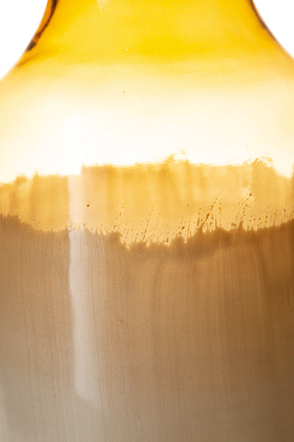 Ceramic vase close-up showing amber glaze drip and cream-to-gray gradient body.