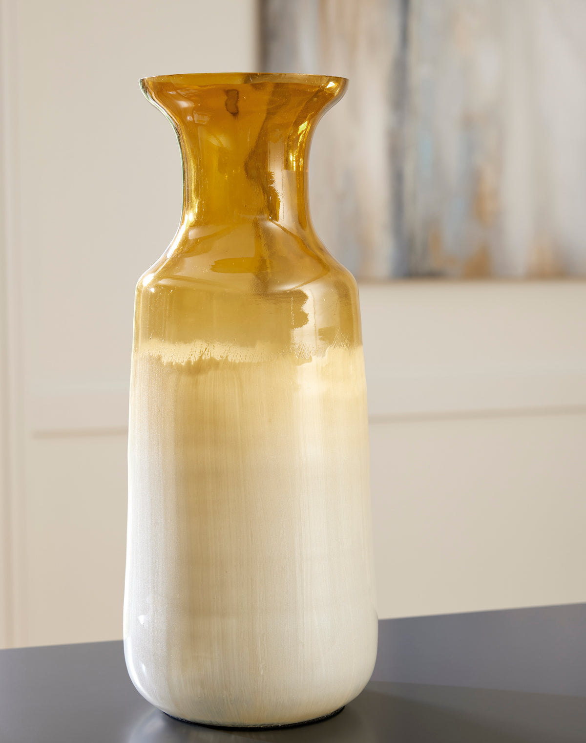 Tall glazed ceramic vase, amber glossy neck and smooth cream-to-gray lower body.