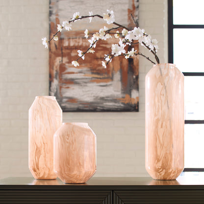 Peach glass vases with wavy finish and white blossoms arrangement