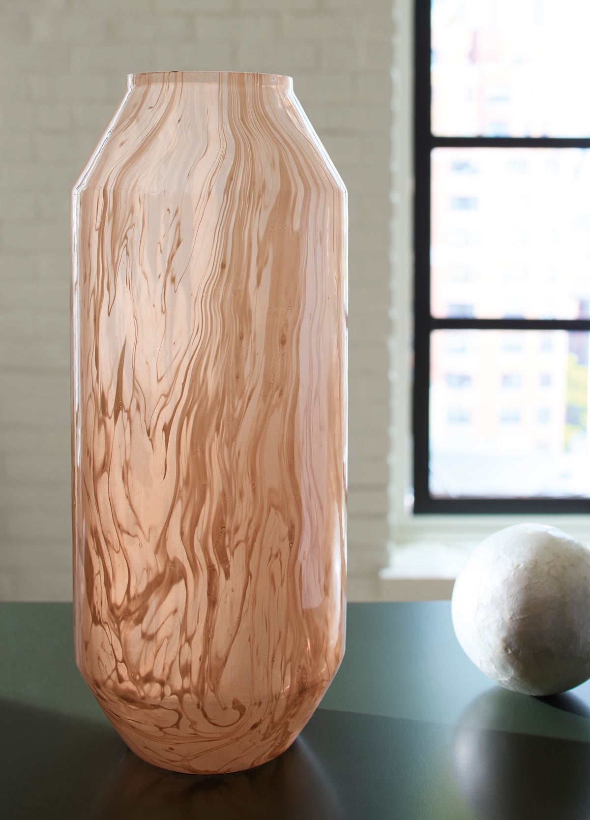 Peach glass vase with vertical wave design and flared lip