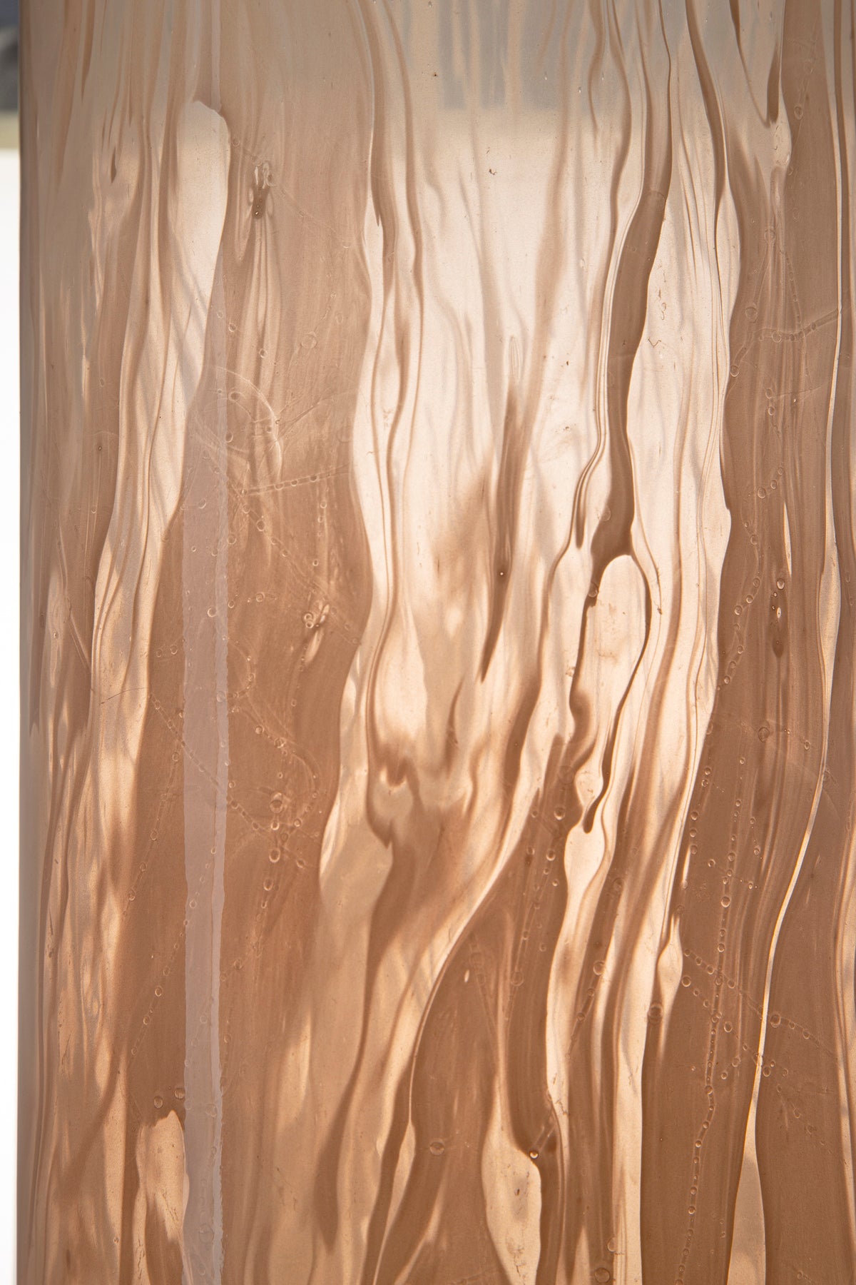 Amber glass vase with vertical wavy surface texture