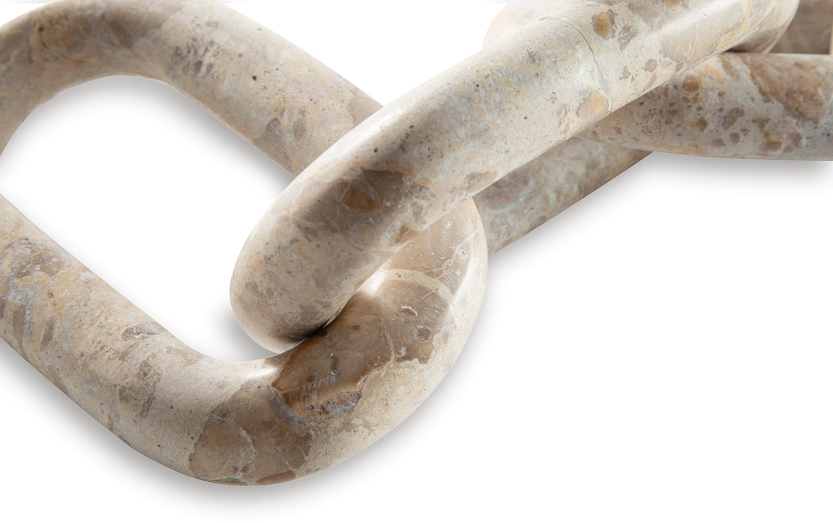 Interlocking chain-link sculpture detail with speckled finish and curved links