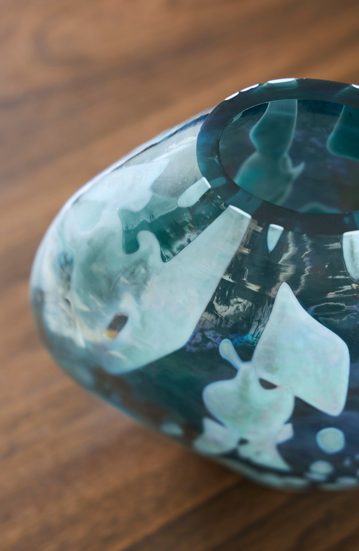 Teal glass vase angled view showing glossy marbled pattern and taper