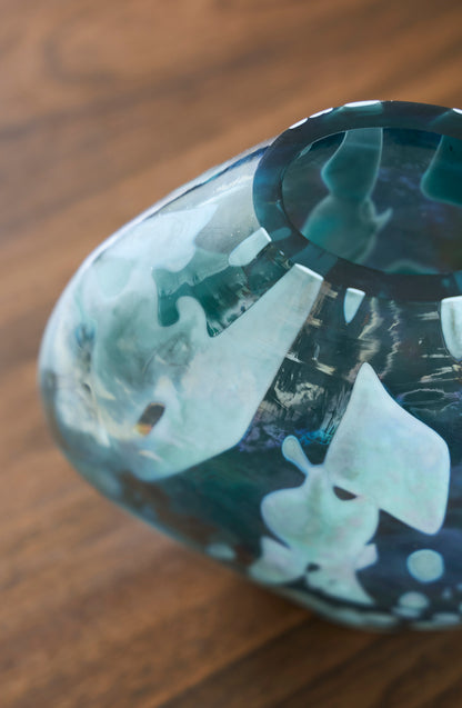 Teal glass vase angled view showing glossy marbled pattern and taper