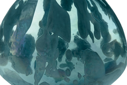 Teal glass vase close-up with glossy reflective swirls and curved opening
