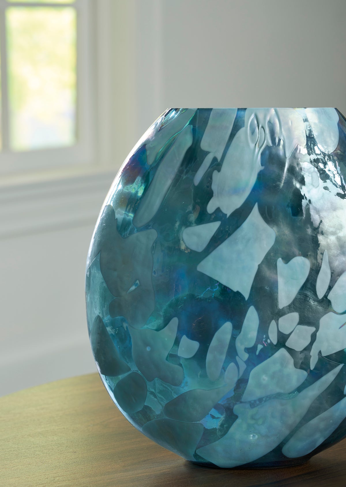 Teal glass vase side view with glossy glaze and fluted top rim