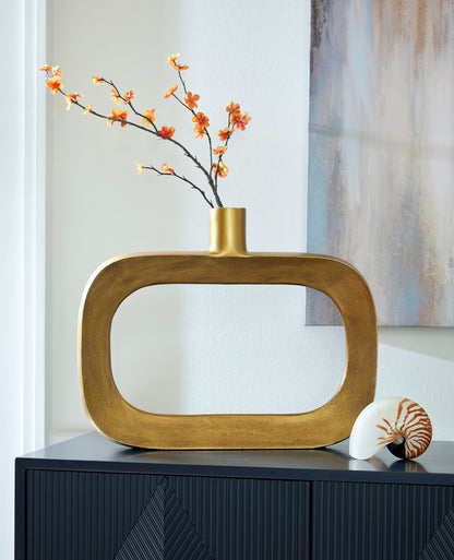 Gold-toned sculptural vase with oval cutout and cylindrical neck, with orange blossoms