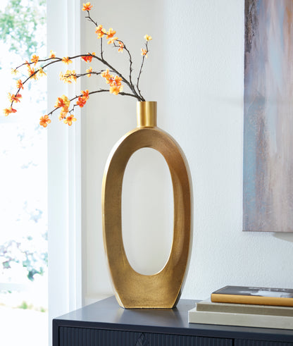 Tall gold-toned vase with oval cutout and cylindrical neck, orange blossoms
