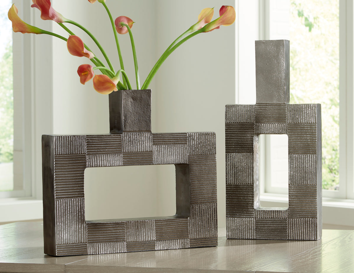 Decorative dark gray metal framed vase with geometric open center, square base.