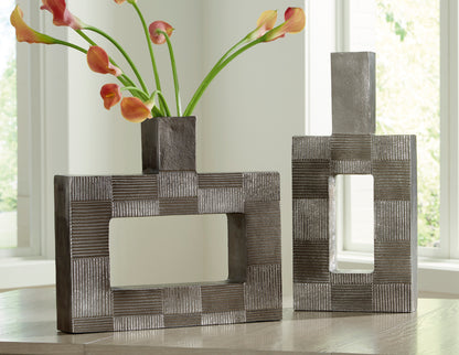 Decorative dark gray metal framed vase with geometric open center, square base.