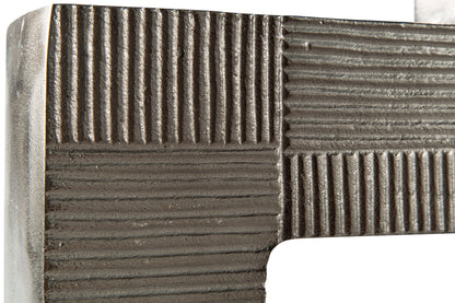 Close-up of textured metal vase top edge with striped block detailing, dark gray