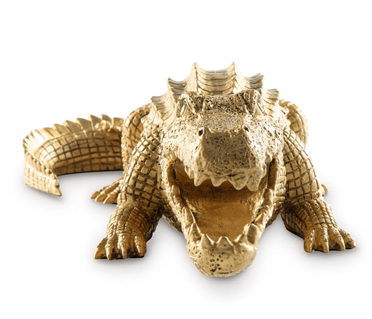 Gold crocodile sculpture figurine curled low, open mouth and ridged head.