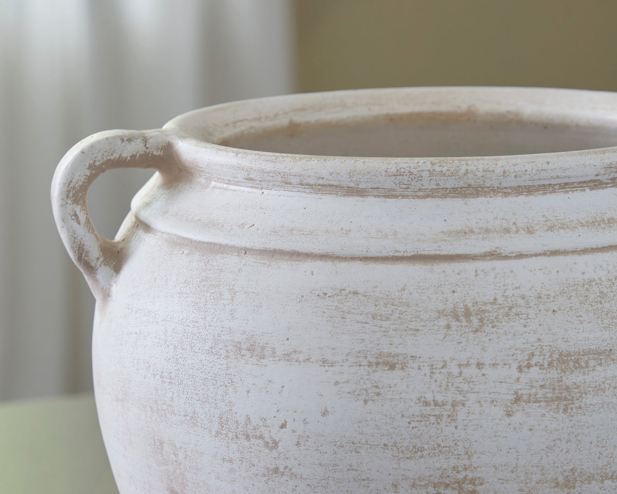 White distressed ceramic vase with side handles, close-up rim and texture