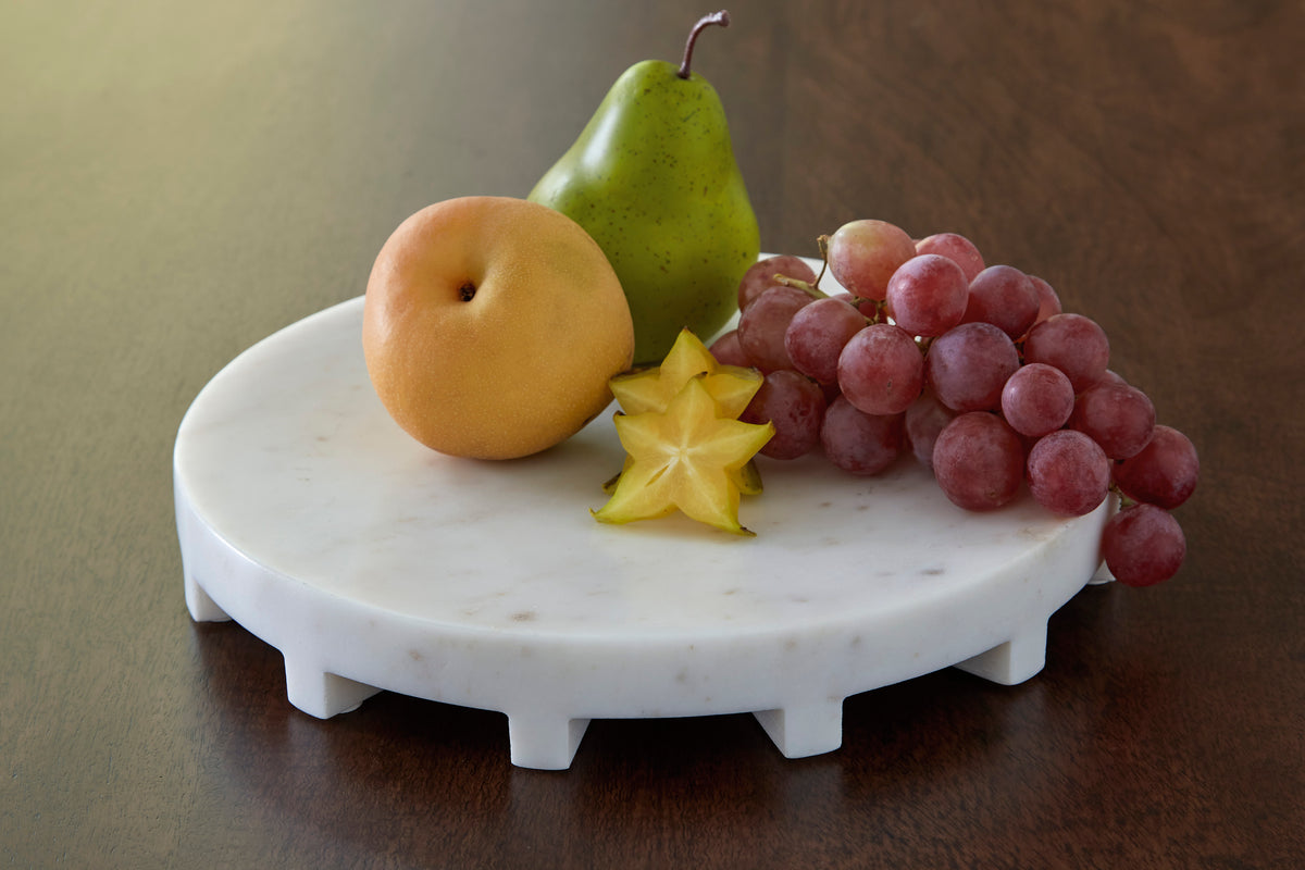 Round white ceramic serving tray with small scalloped feet