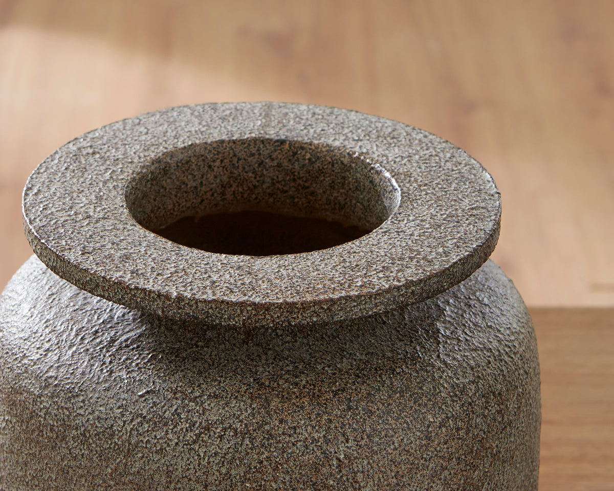 Close-up of textured vase top with wide circular opening, dark gray speckle
