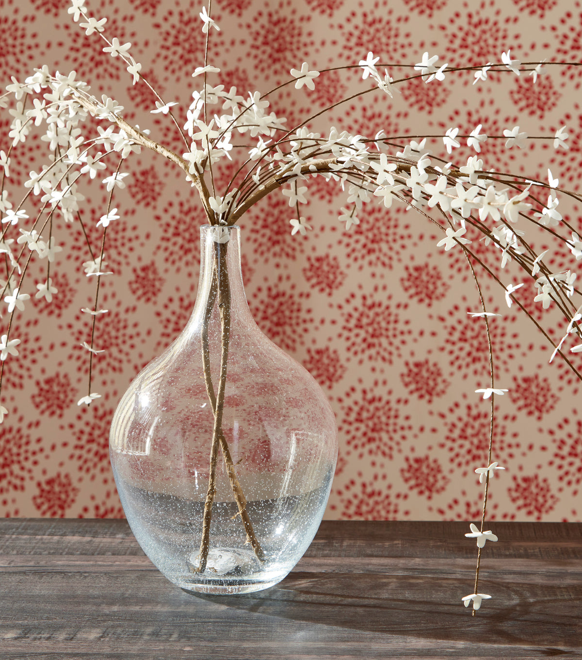 Glass vase with narrow neck, round bulb body, and clear speckled finish