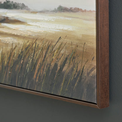 Close-up of framed landscape wall art with textured grasses and wood edge