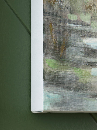 Close-up of textured wall art edge in white frame with green paint