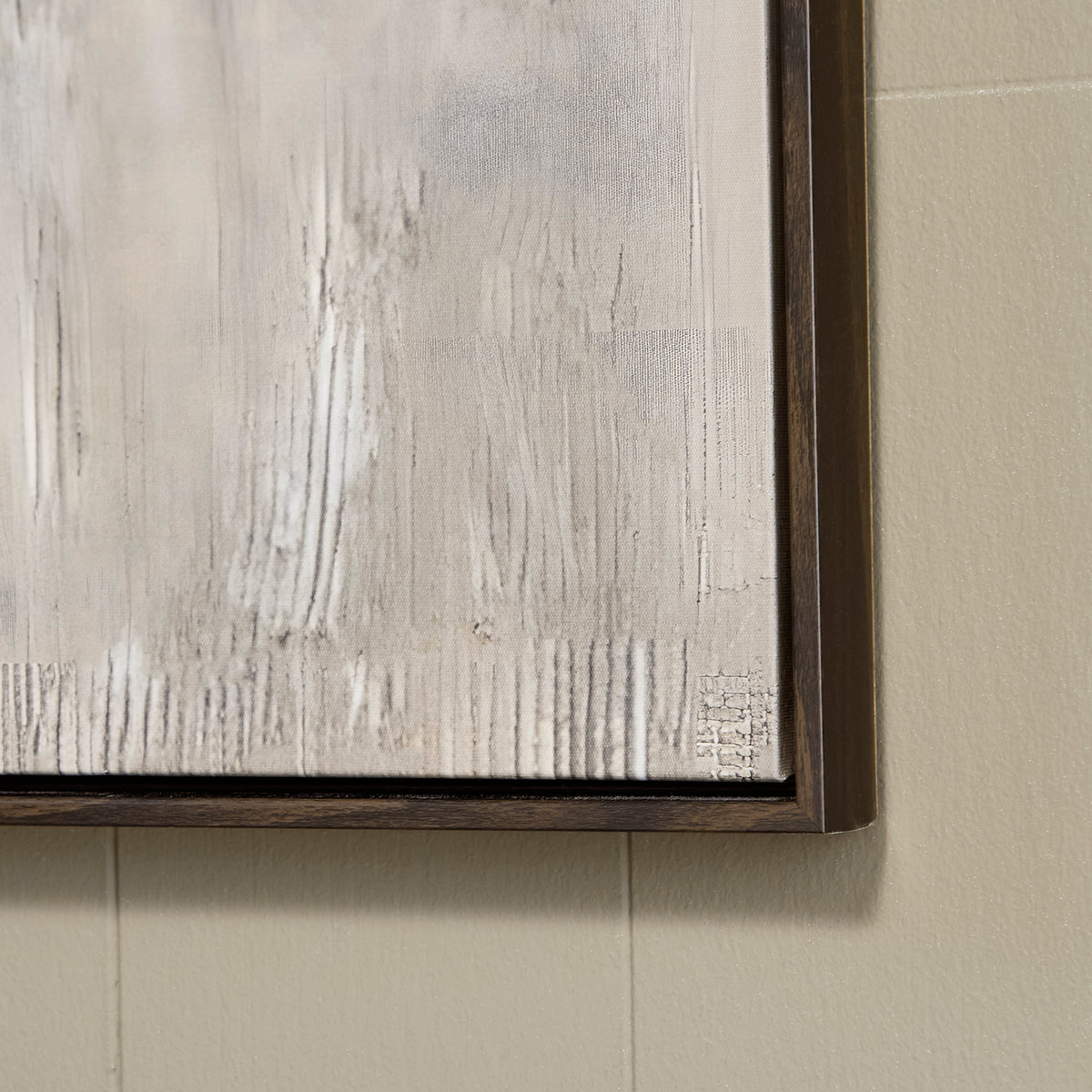 Close-up of framed wall art showing textured white paint strokes and dark edges