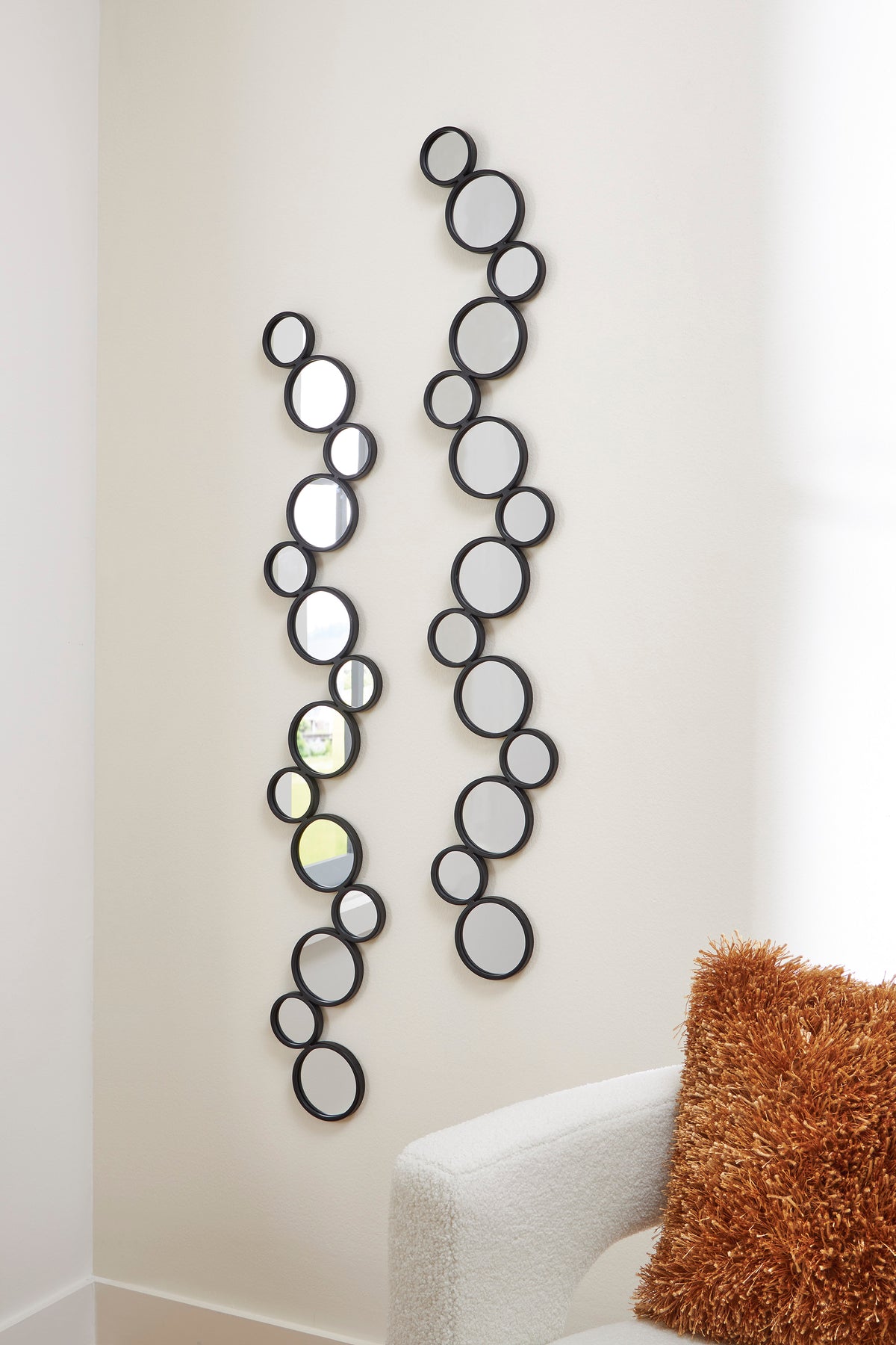 Set of 2 vertical round accent mirrors with dark frames and reflective glass