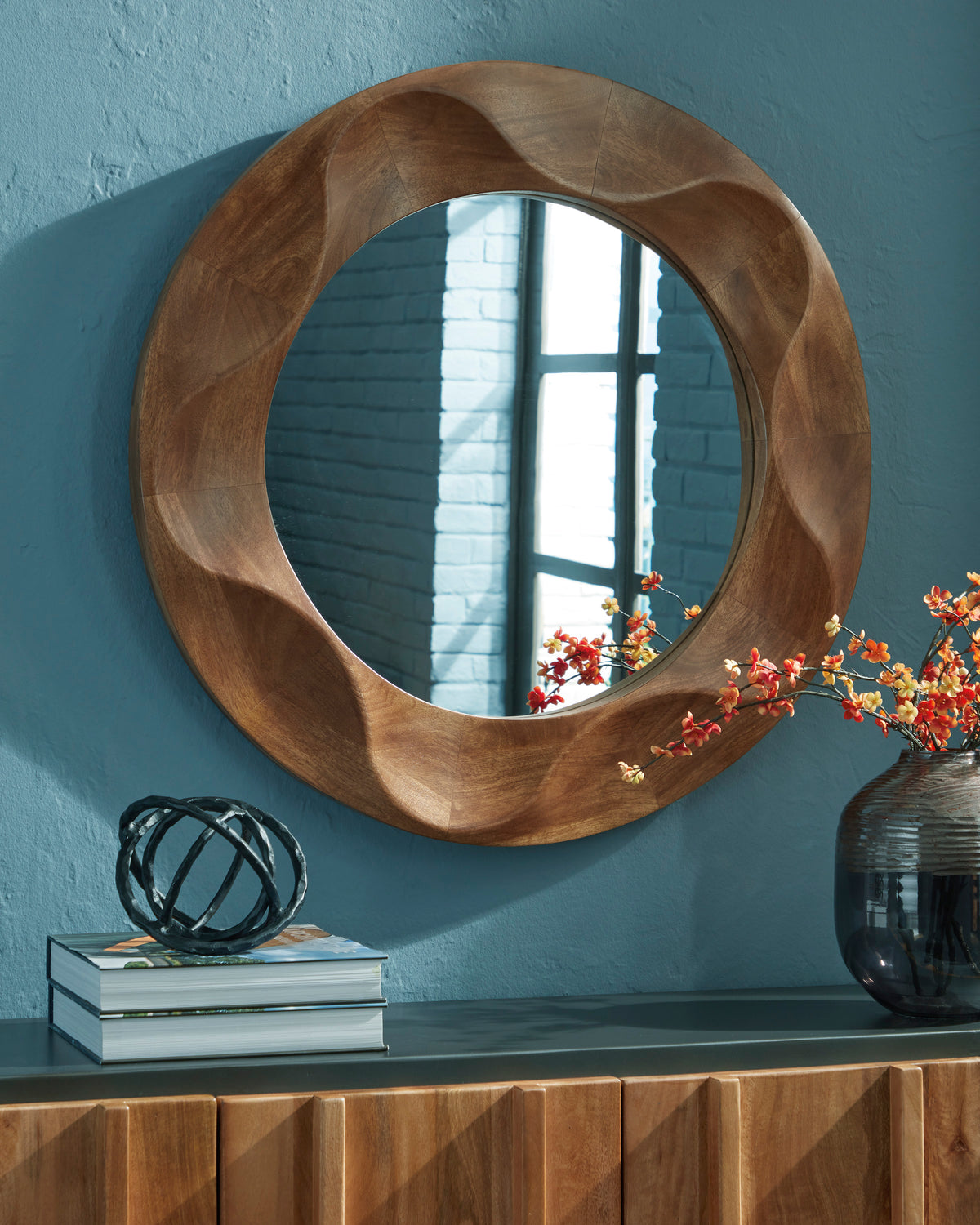 Walnut-finish accent wall mirror with oval frame and curved sculpted border