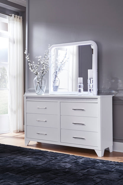 White dresser with arched mirror and multiple drawer fronts