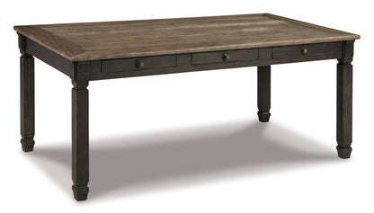 Rustic dark wood dining table with rectangular top, three drawers, and turned legs