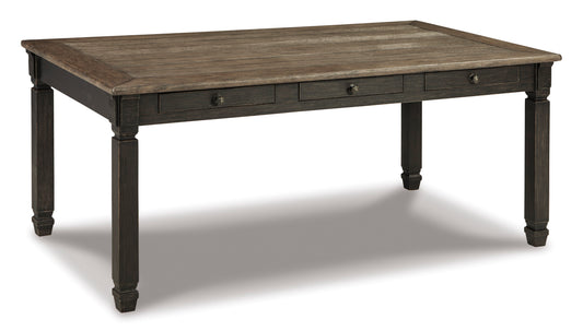 Rustic dark wood dining table with rectangular top, three drawers, and turned legs