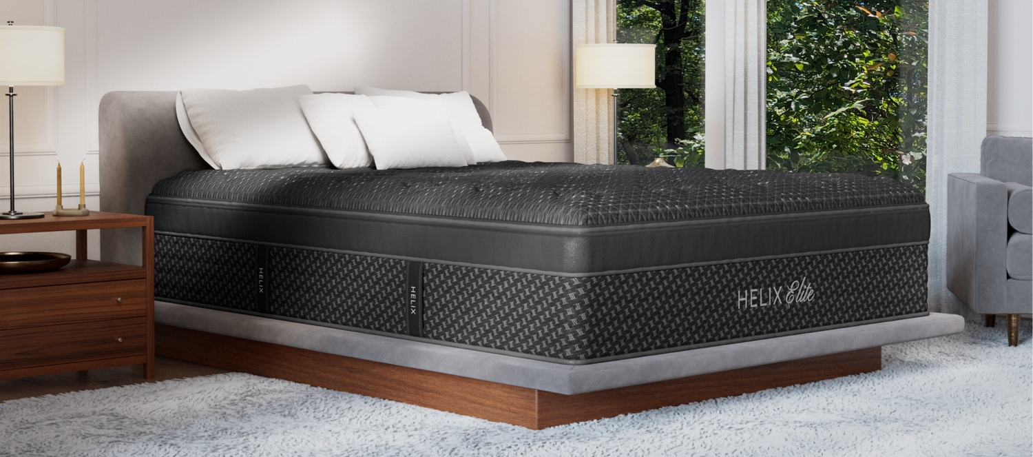 Helix mattress in a bedroom setting with a nightstand and window view.