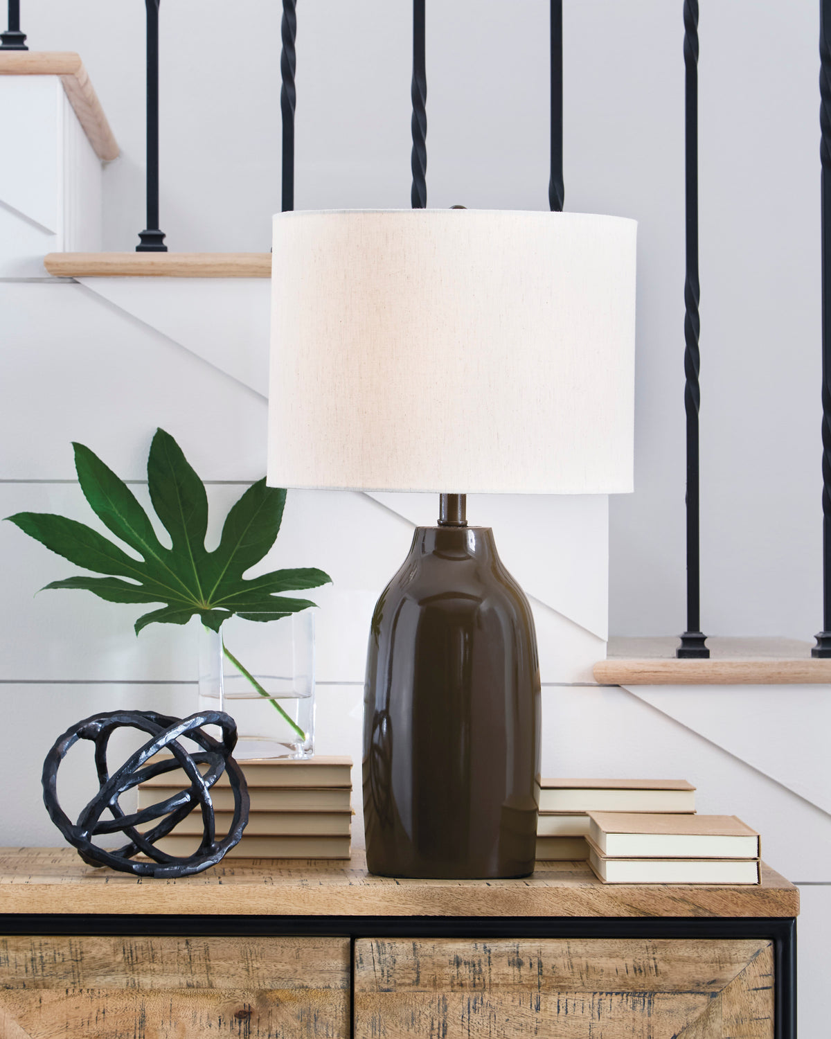 Table lamp with off-white fabric shade and dark brown ceramic base
