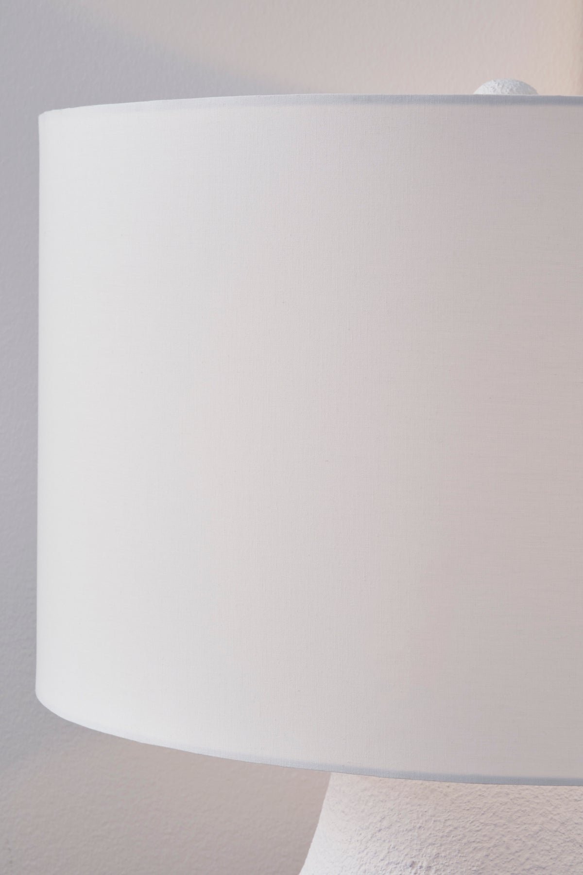 White drum lamp shade with metal base top, close-up