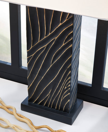 Black table lamp base with gold wavy line pattern and white fabric shade