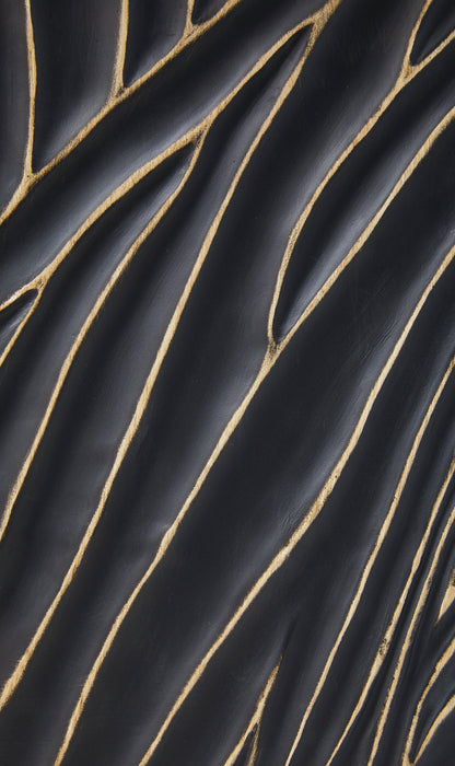 Close-up of black lamp base with gold curved line texture