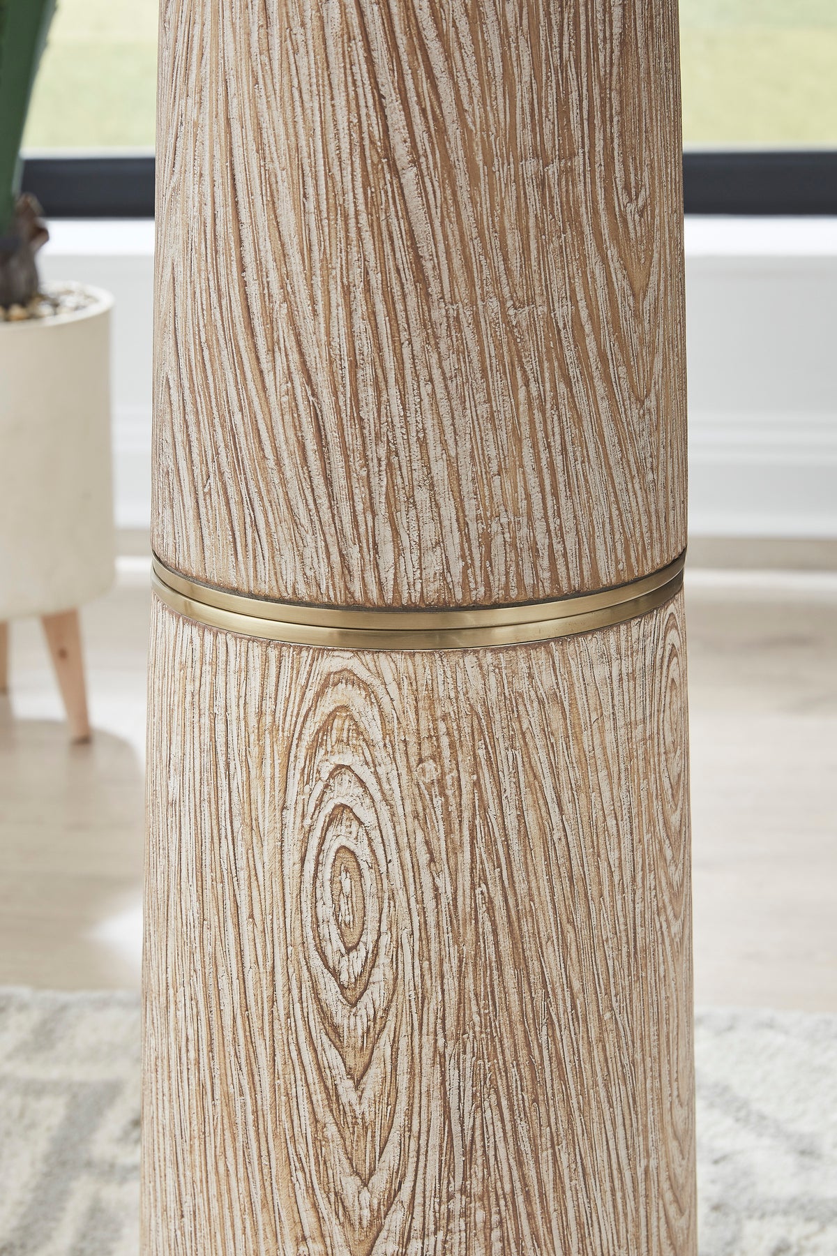 Close-up of wood-look poly floor lamp base with carved oval detail and gold band