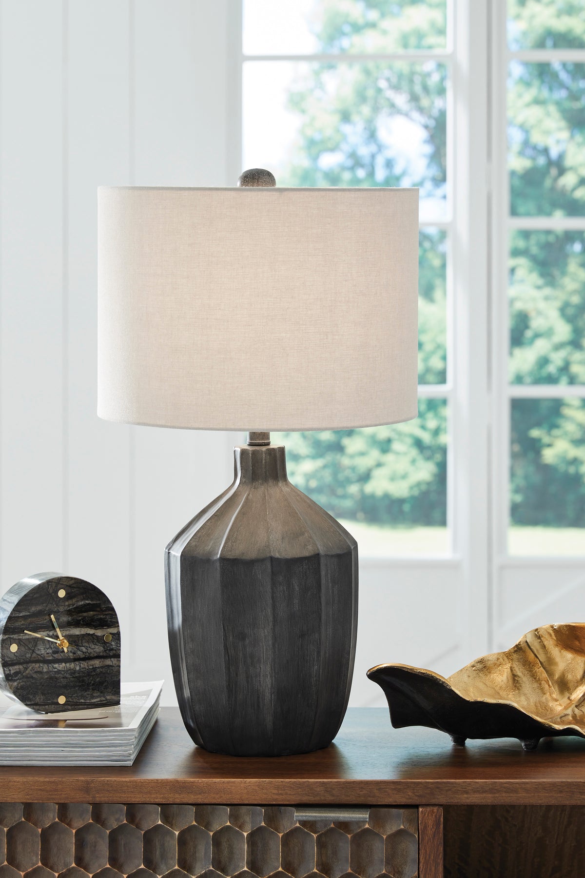 Poly table lamp with beige fabric shade and dark gray sculpted base